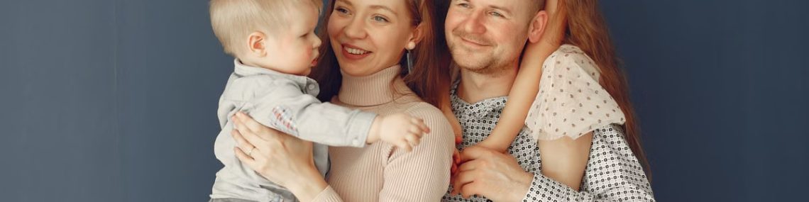 A joyful family portrait showcasing parents and their two children, expressing love and togetherness.